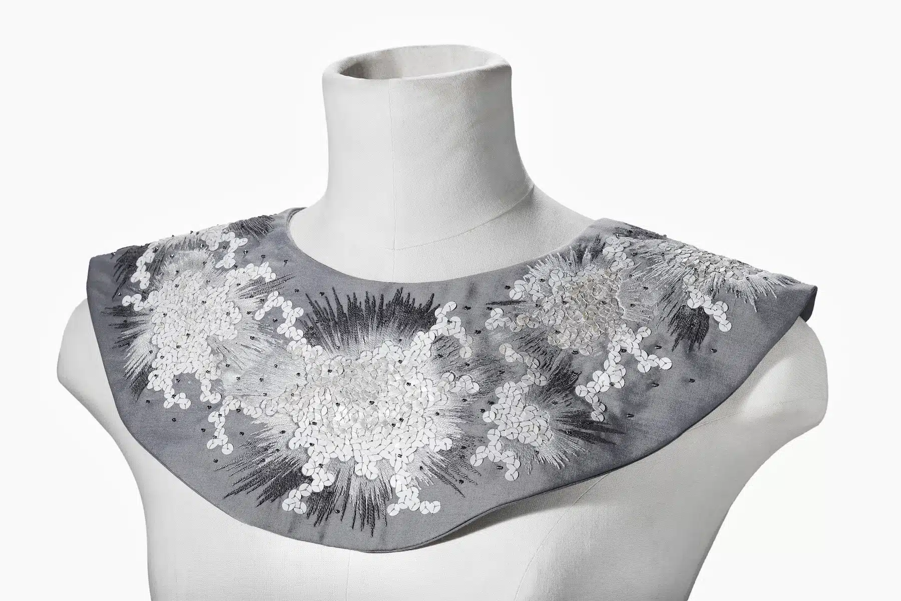  Silver and grey wide embroidered collar shown on white dress mannequin.